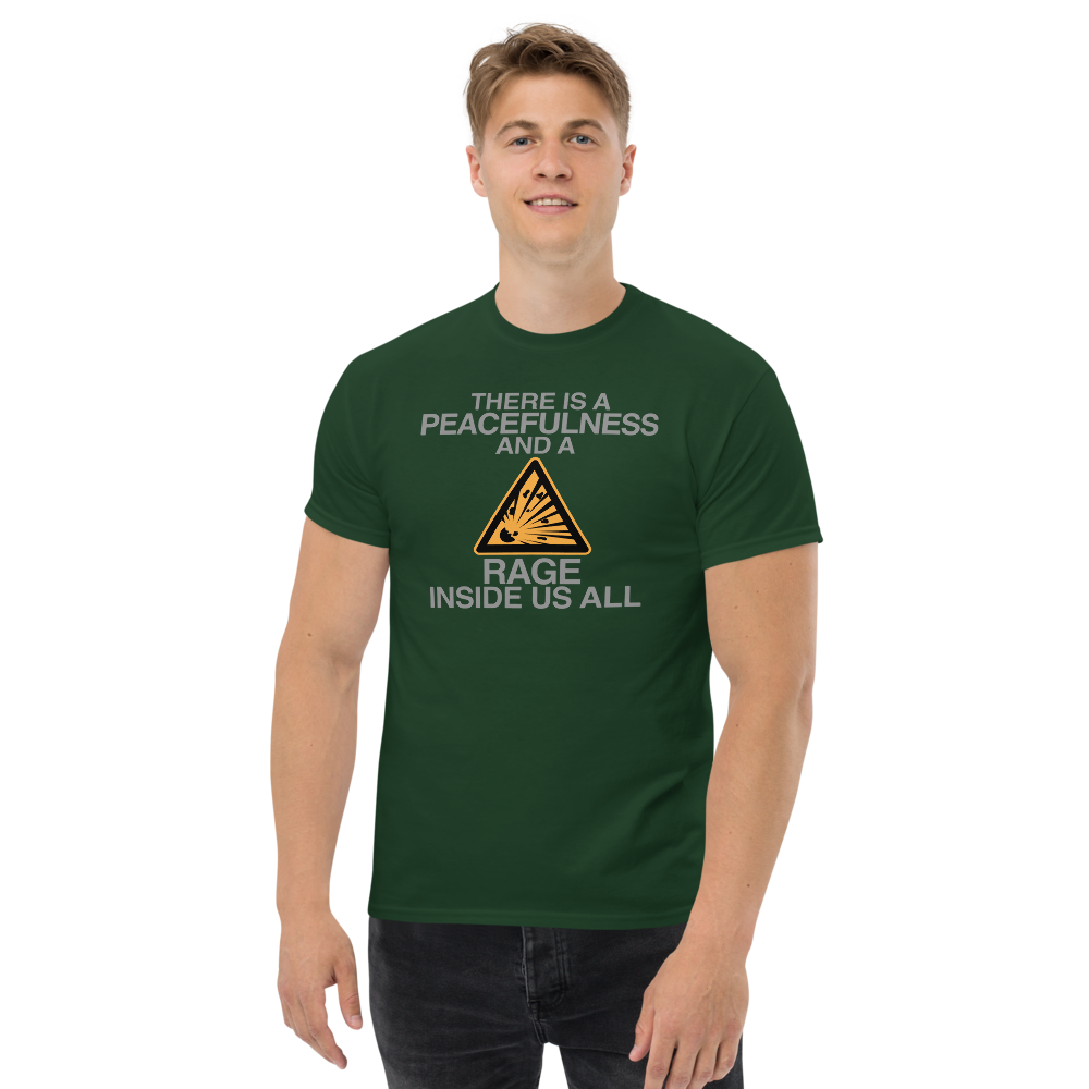 "There is a peacefulness and a rage inside us all" printed on a forest green unisex classic tee worn by a male