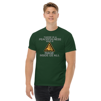 "There is a peacefulness and a rage inside us all" printed on a forest green unisex classic tee worn by a male