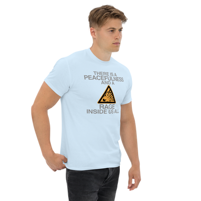 "There is a peacefulness and a rage inside us all" printed on a light blue unisex classic tee worn by a male