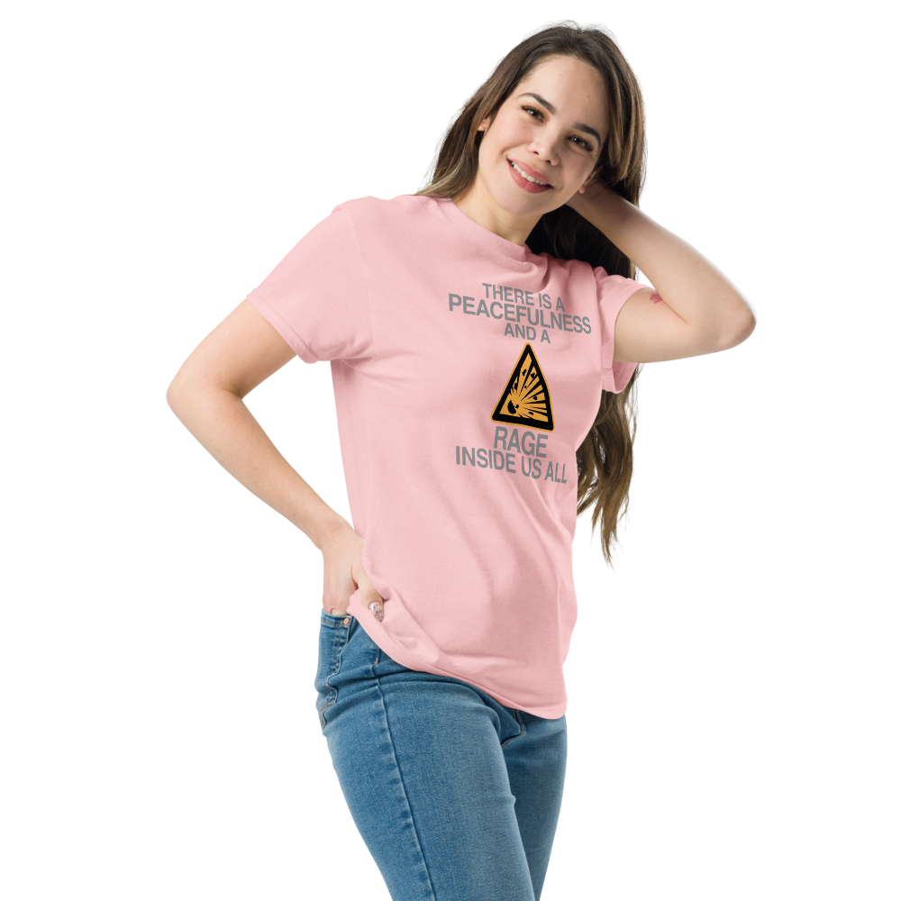 "There is a peacefulness and a rage inside us all" printed on a light pink unisex classic tee worn by a female