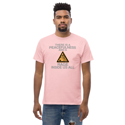 "There is a peacefulness and a rage inside us all" printed on a light pink unisex classic tee worn by a male