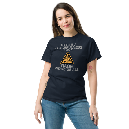"There is a peacefulness and a rage inside us all" printed on a navy unisex classic tee worn by a female
