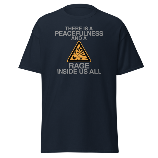 "There is a peacefulness and a rage inside us all" printed on a navy unisex classic tee laying on a flat surface