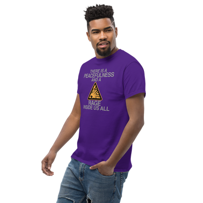 "There is a peacefulness and a rage inside us all" printed on a purple unisex classic tee worn by a male