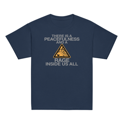 "There is a peacefulness and a rage inside us all" printed on a navy youth classic tee laying on a flat surface