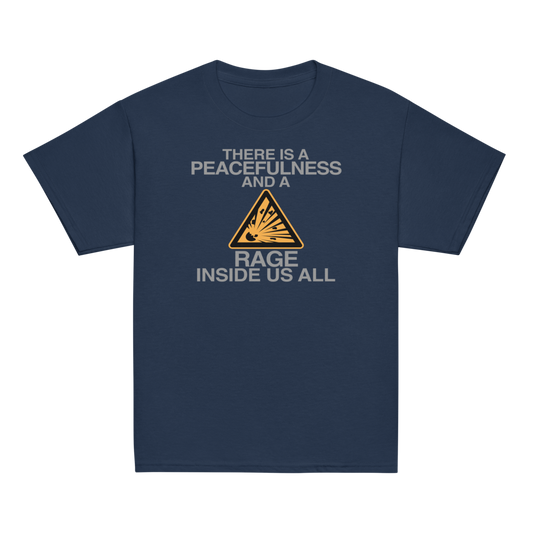 "There is a peacefulness and a rage inside us all" printed on a navy youth classic tee laying on a flat surface