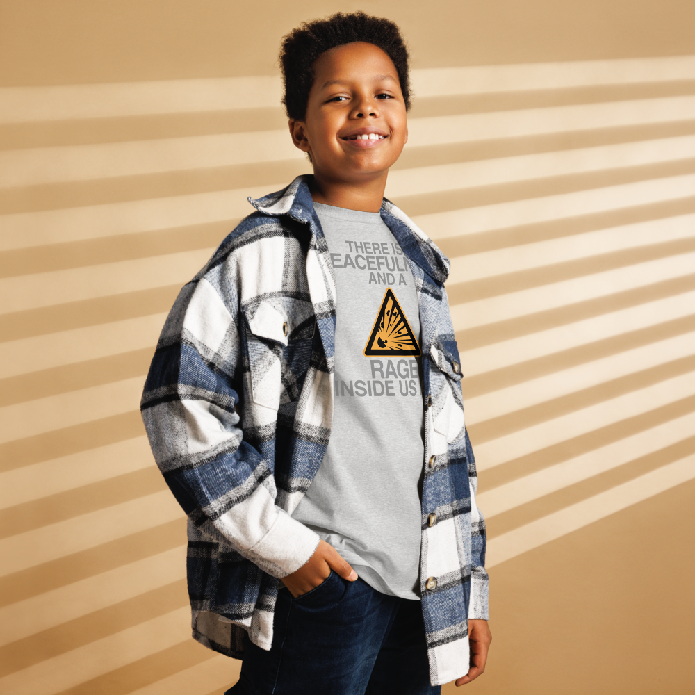 "There is a peacefulness and a rage inside us all" printed on a sport grey youth classic tee worn by a male also wearing a jacket