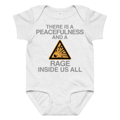 "There is a peacefulness and a rage inside us all" printed on a ash baby jersey bodysuit laying on a flat surface amongst other clothes