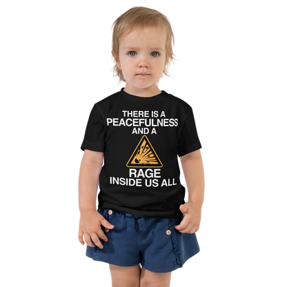 "There is a peacefulness and a rage inside us all" printed on a black toddler short sleeve tee worn by a female