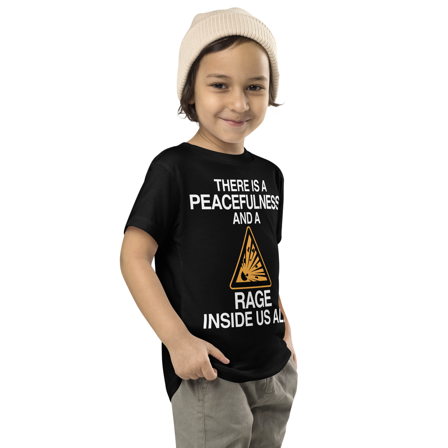 "There is a peacefulness and a rage inside us all" printed on a black toddler short sleeve tee worn by a male who is also wearing a knit cap