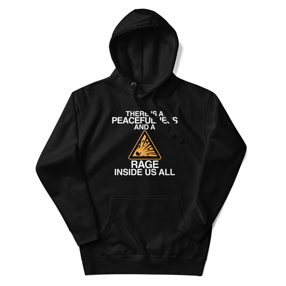 "There is a peacefulness and a rage inside us all" printed on a black unisex hoodie laying on a flat surface with the hood up