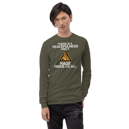 "There is a peacefulness and a rage inside us all" printed on a military green men's long sleeve shirt worn by a male