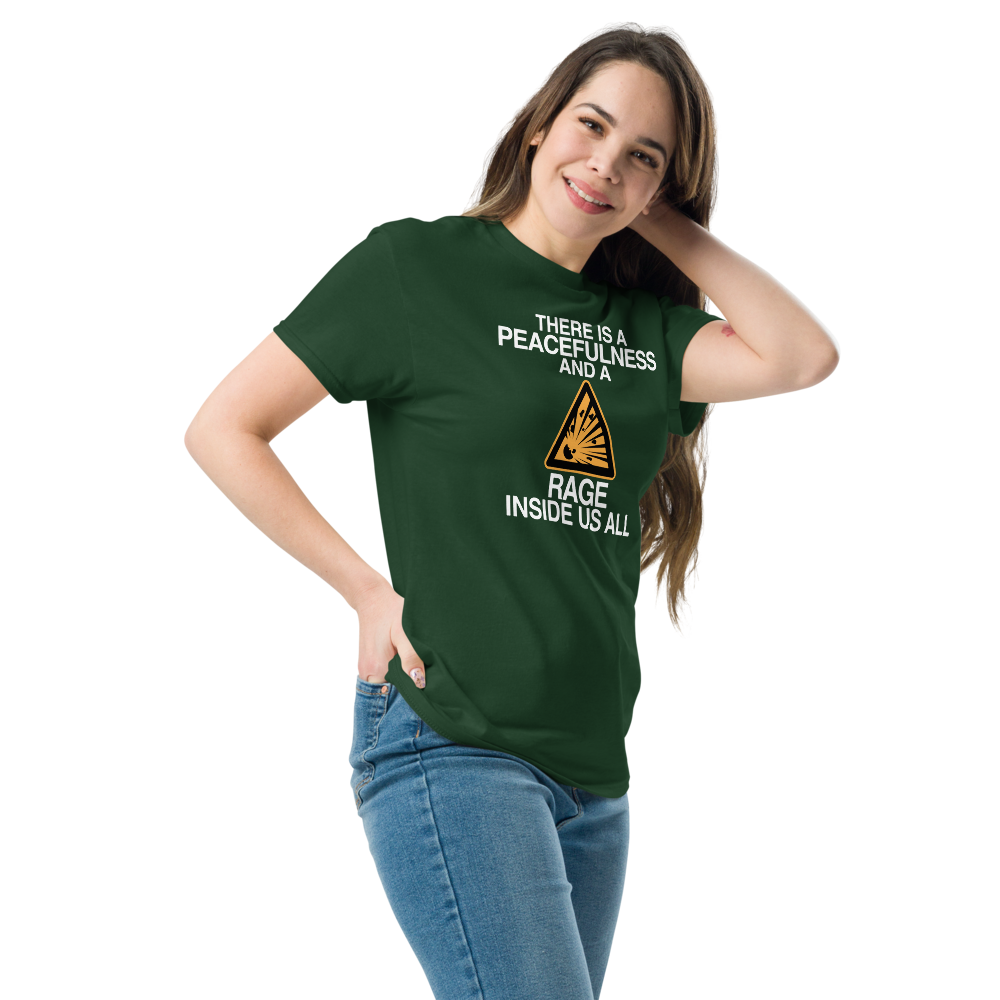 "There is a peacefulness and a rage inside us all" printed on a forest green unisex classic tee worn by a female