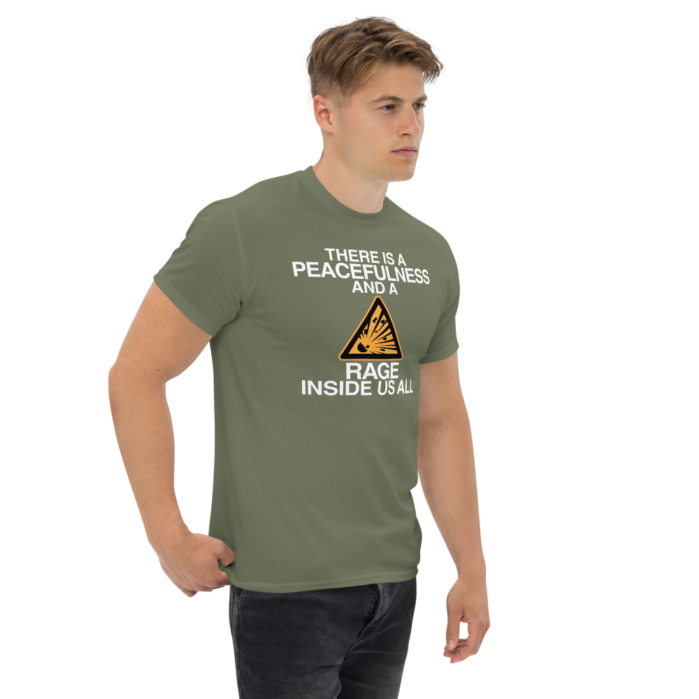 "There is a peacefulness and a rage inside us all" printed on a military green unisex classic tee worn by a male