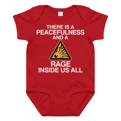 "There is a peacefulness and a rage inside us all" printed on a red baby jersey bodysuit laying on a flat surface amongst other clothes