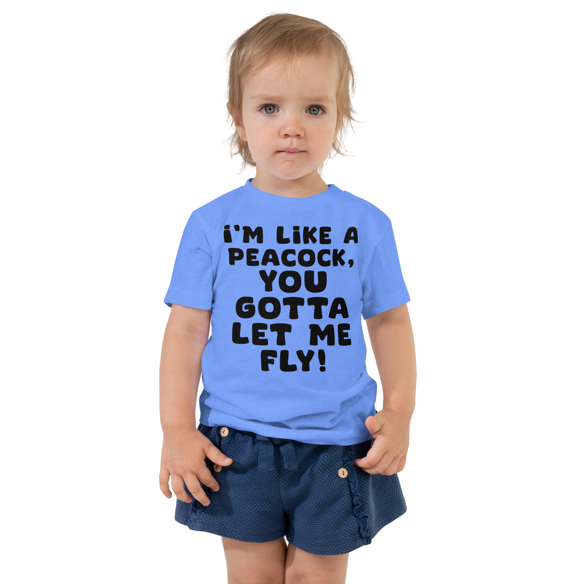 "I'm like a peacock, you gotta let me fly!" printed on a heather columbia blue toddler short sleeve tee worn by a female