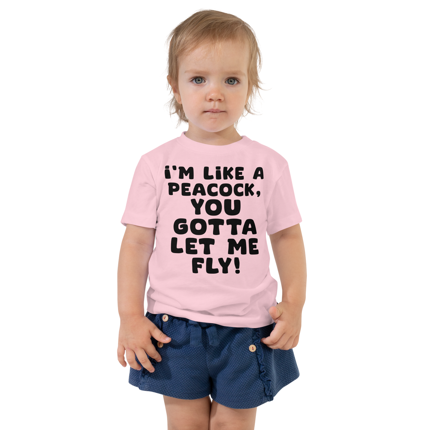 "I'm like a peacock, you gotta let me fly!" printed on a pink toddler short sleeve tee worn by a female