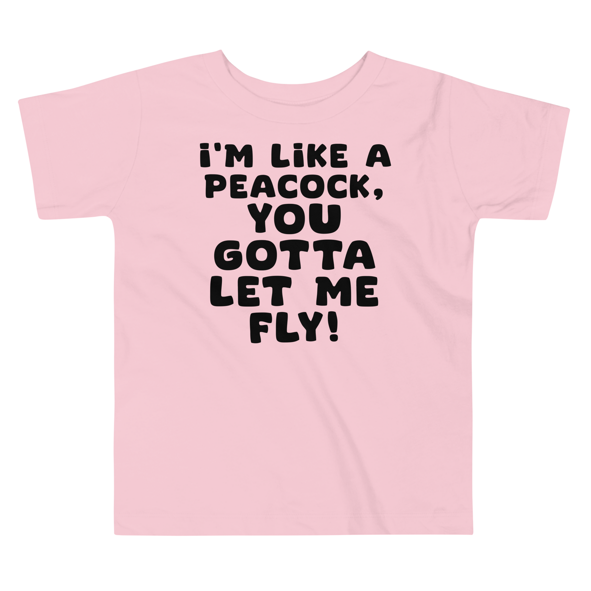 "I'm like a peacock, you gotta let me fly!" printed on a pink toddler short sleeve tee laying on a flat surface