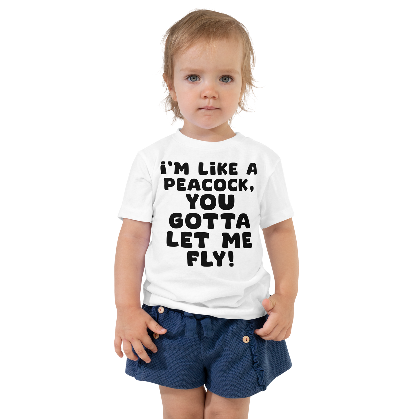 "I'm like a peacock, you gotta let me fly!" printed on a white toddler short sleeve tee worn by a female