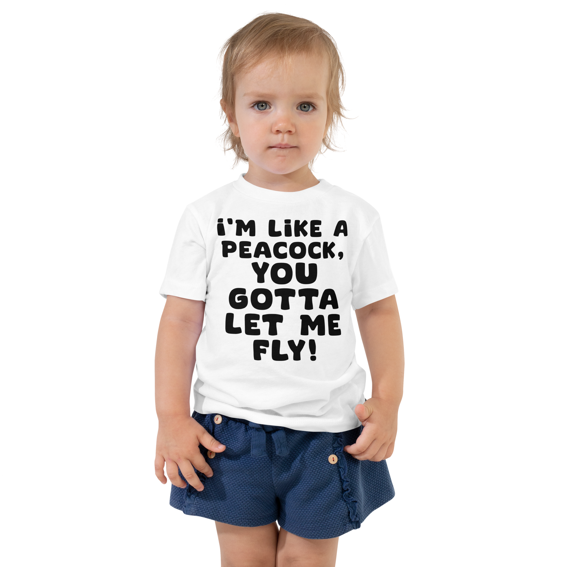 "I'm like a peacock, you gotta let me fly!" printed on a white toddler short sleeve tee worn by a female