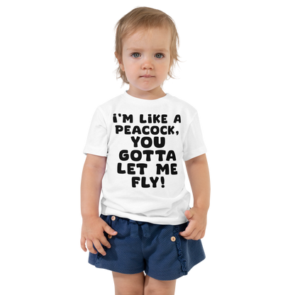 "I'm like a peacock, you gotta let me fly!" printed on a white toddler short sleeve tee worn by a female