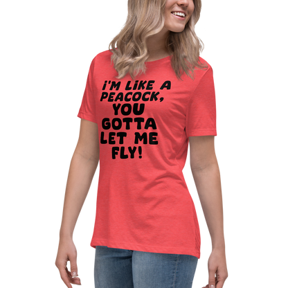 "I'm like a peacock, you gotta let me fly!" printed on a heather red women's relaxed t-shirt worn by a female