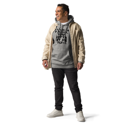 "I'm like a peacock, you gotta let me fly!" printed on a carbon grey unisex hoodie worn by a male with a jacket on top
