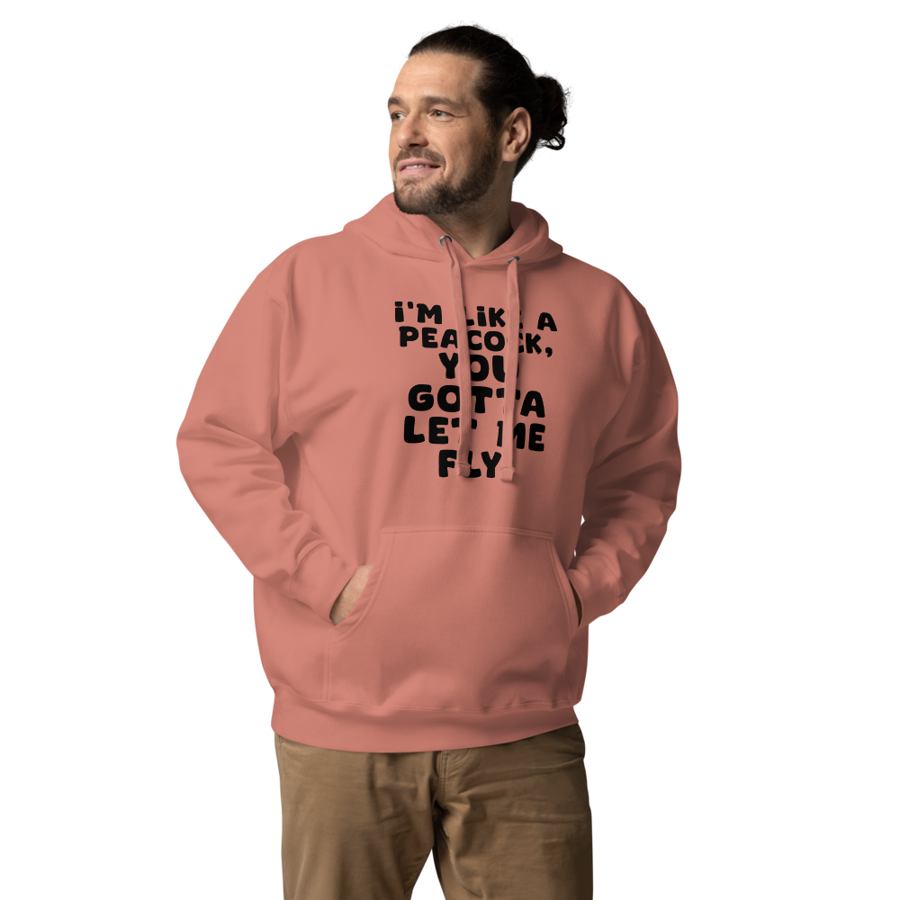 "I'm like a peacock, you gotta let me fly!" printed on a dusty rose unisex hoodie worn by a male