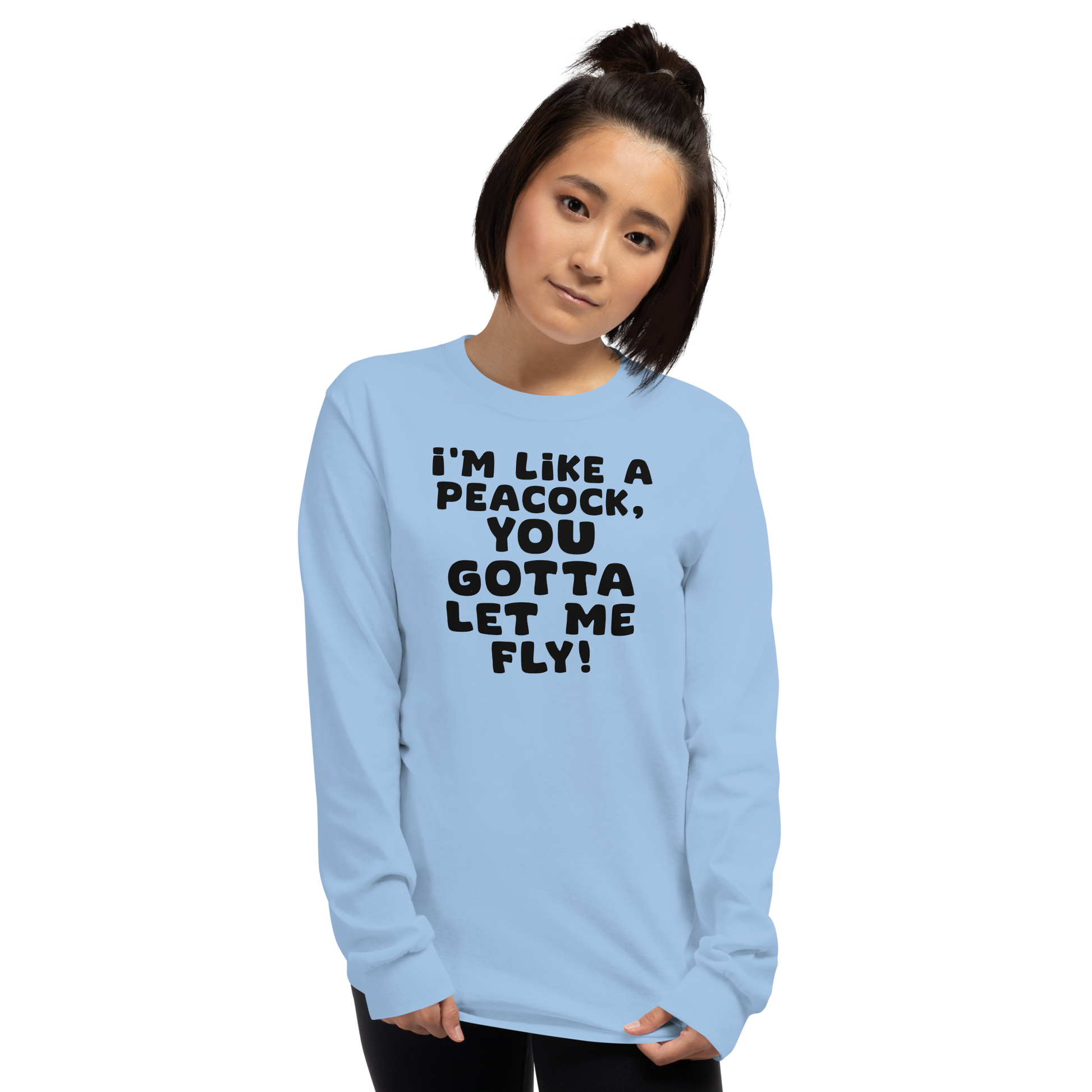 "I'm like a peacock, you gotta let me fly!" printed on a light blue men's long sleeve shirt worn by a female
