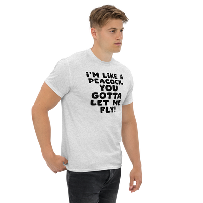 "I'm like a peacock, you gotta let me fly!" printed on a ash unisex classic tee worn by a male