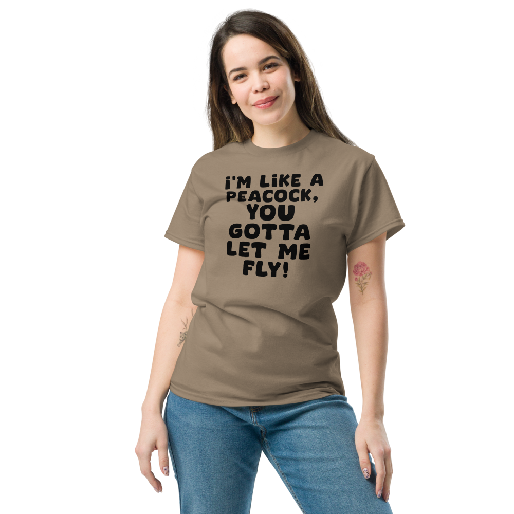 "I'm like a peacock, you gotta let me fly!" printed on a brown savana unisex classic tee worn by a female