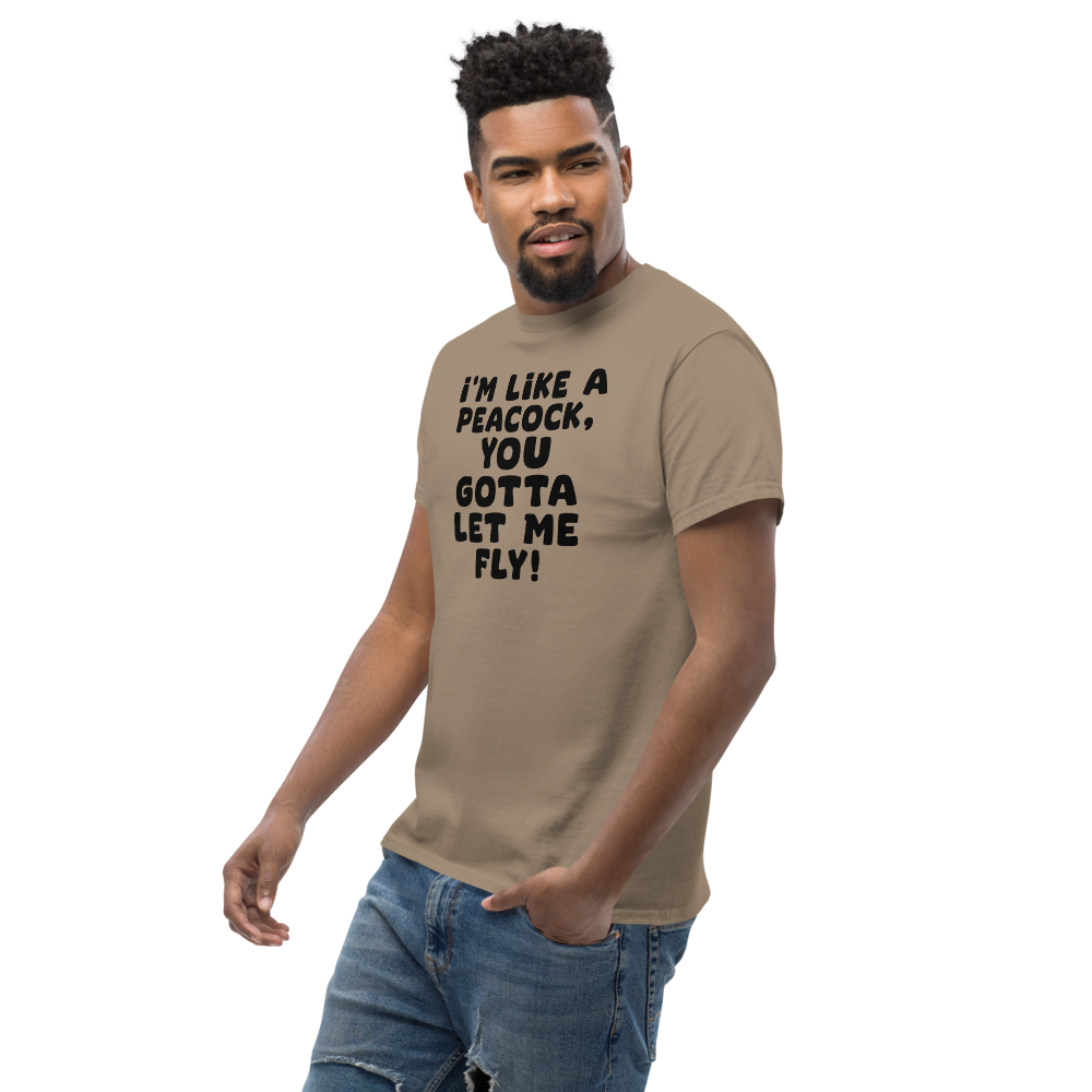 "I'm like a peacock, you gotta let me fly!" printed on a brown savana unisex classic tee worn by a male
