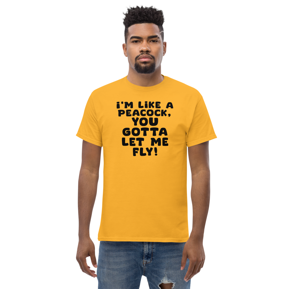 "I'm like a peacock, you gotta let me fly!" printed on a gold unisex classic tee worn by a male
