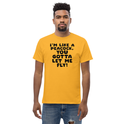 "I'm like a peacock, you gotta let me fly!" printed on a gold unisex classic tee worn by a male