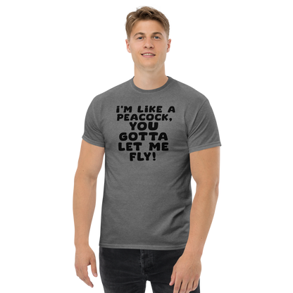 "I'm like a peacock, you gotta let me fly!" printed on a graphite heather unisex classic tee worn by a male