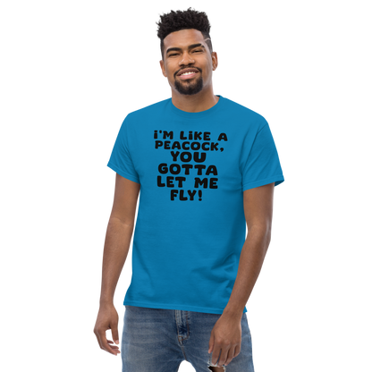 "I'm like a peacock, you gotta let me fly!" printed on a sapphire unisex classic tee worn by a male