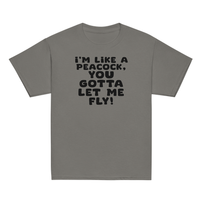 "I'm like a peacock, you gotta let me fly!" printed on a charcoal youth classic tee laying on a flat surface