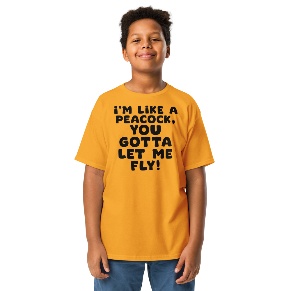 "I'm like a peacock, you gotta let me fly!" printed on a gold youth classic tee worn by a male