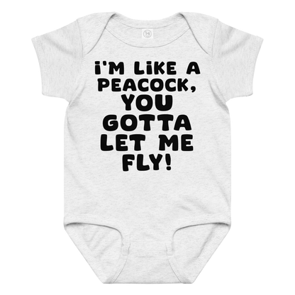 "I'm like a peacock, you gotta let me fly!" printed on a ash baby jersey bodysuit laying on a flat surface amongst other clothes