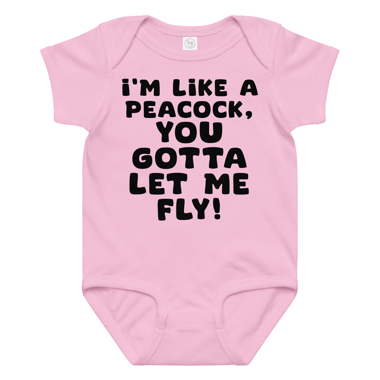 "I'm like a peacock, you gotta let me fly!" printed on a pink baby jersey bodysuit laying on a flat surface amongst other clothes