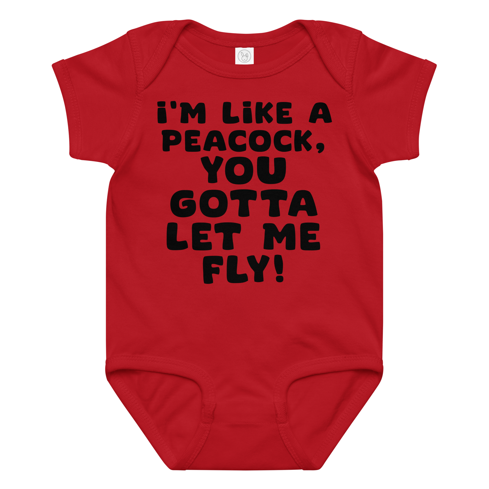 "I'm like a peacock, you gotta let me fly!" printed on a red baby jersey bodysuit laying on a flat surface amongst other clothes