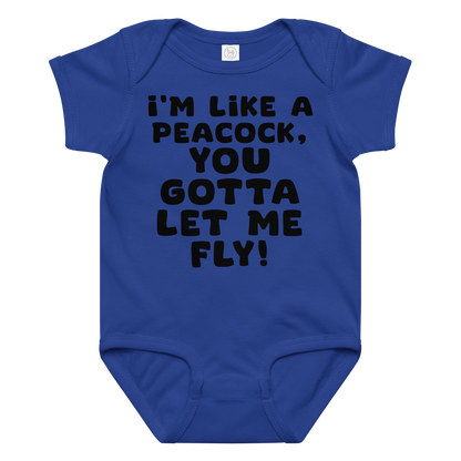 "I'm like a peacock, you gotta let me fly!" printed on a royal baby jersey bodysuit laying on a flat surface amongst other clothes