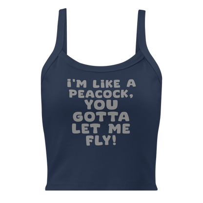 "I'm like a peacock, you gotta let me fly!" printed on a solid navy blend women's micro-rib tanktop laying on a flat surface