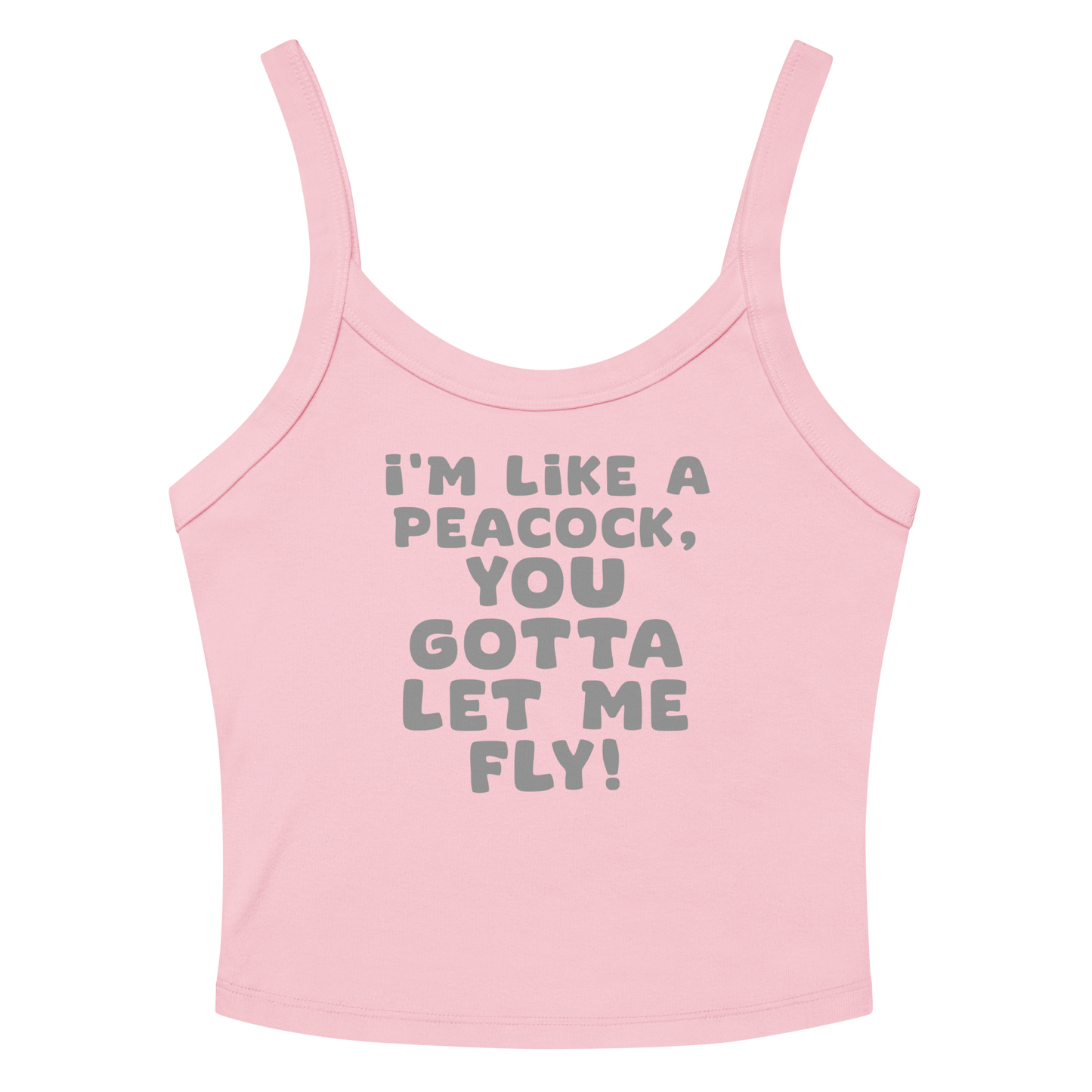 "I'm like a peacock, you gotta let me fly!" printed on a solid pink blend women's micro-rib tanktop laying on a flat surface amongst sunglasses and shorts