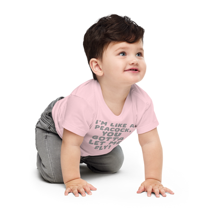 "I'm like a peacock, you gotta let me fly!" printed on a pink baby jersey short sleeve tee worn by a male who is crawling