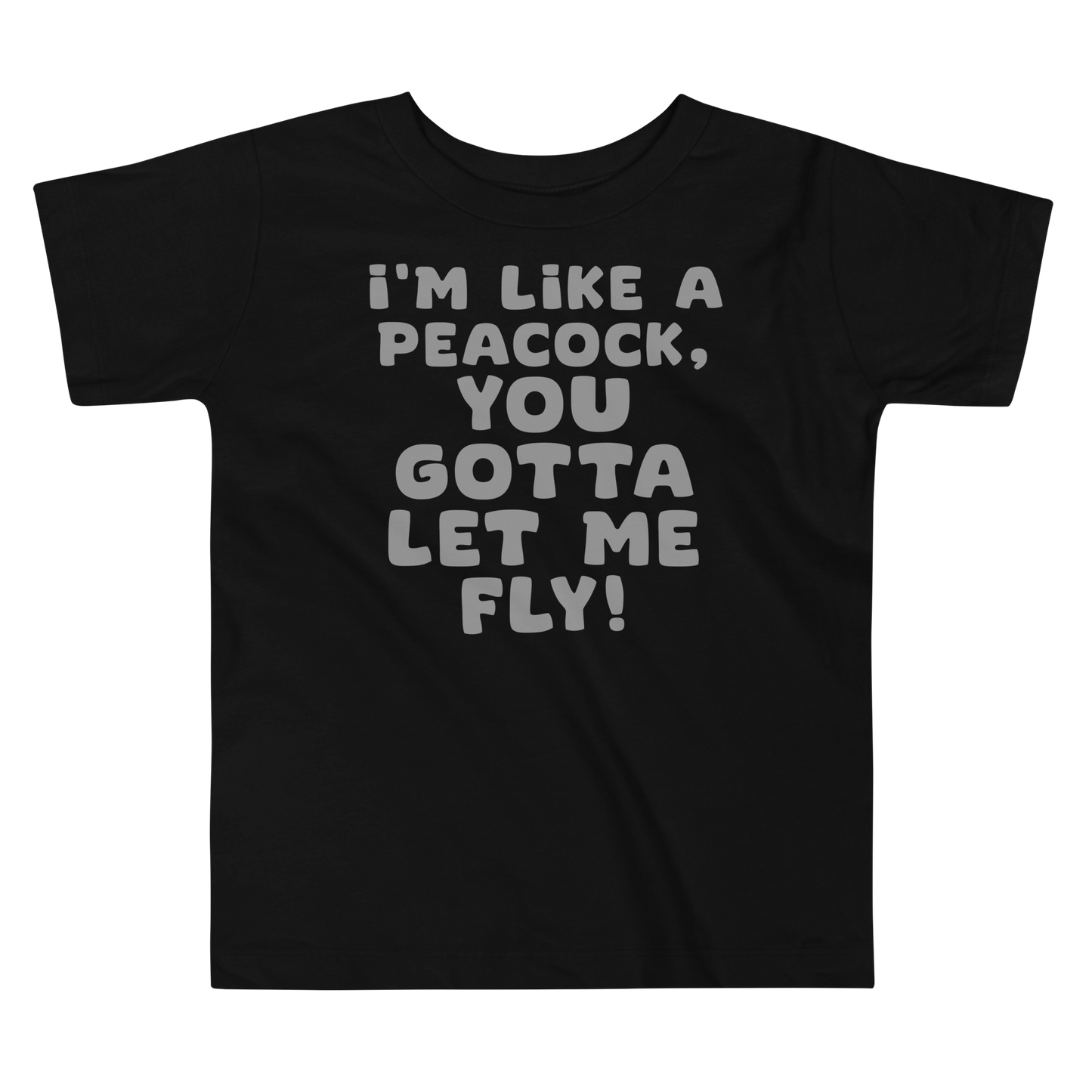 "I'm like a peacock, you gotta let me fly!" printed on a black toddler short sleeve tee laying on a flat surface