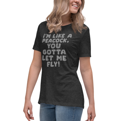 "I'm like a peacock, you gotta let me fly!" printed on a dark grey heather women's relaxed t-shirt worn by a female