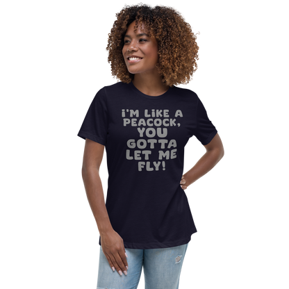 "I'm like a peacock, you gotta let me fly!" printed on a navy women's relaxed t-shirt worn by a female