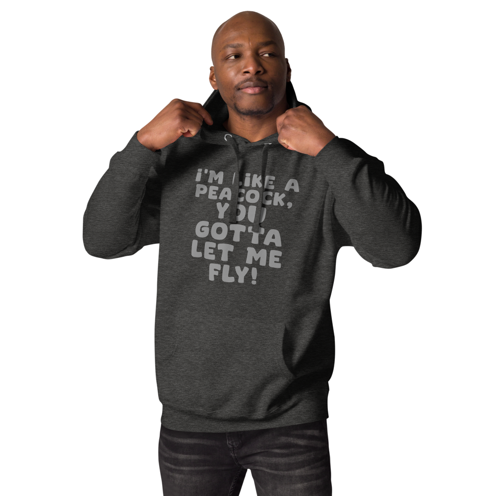 "I'm like a peacock, you gotta let me fly!" printed on a charcoal heather unisex hoodie worn by a male