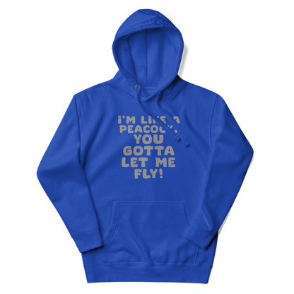 "I'm like a peacock, you gotta let me fly!" printed on a team royal unisex hoodie laying on a flat surface with the hood up
